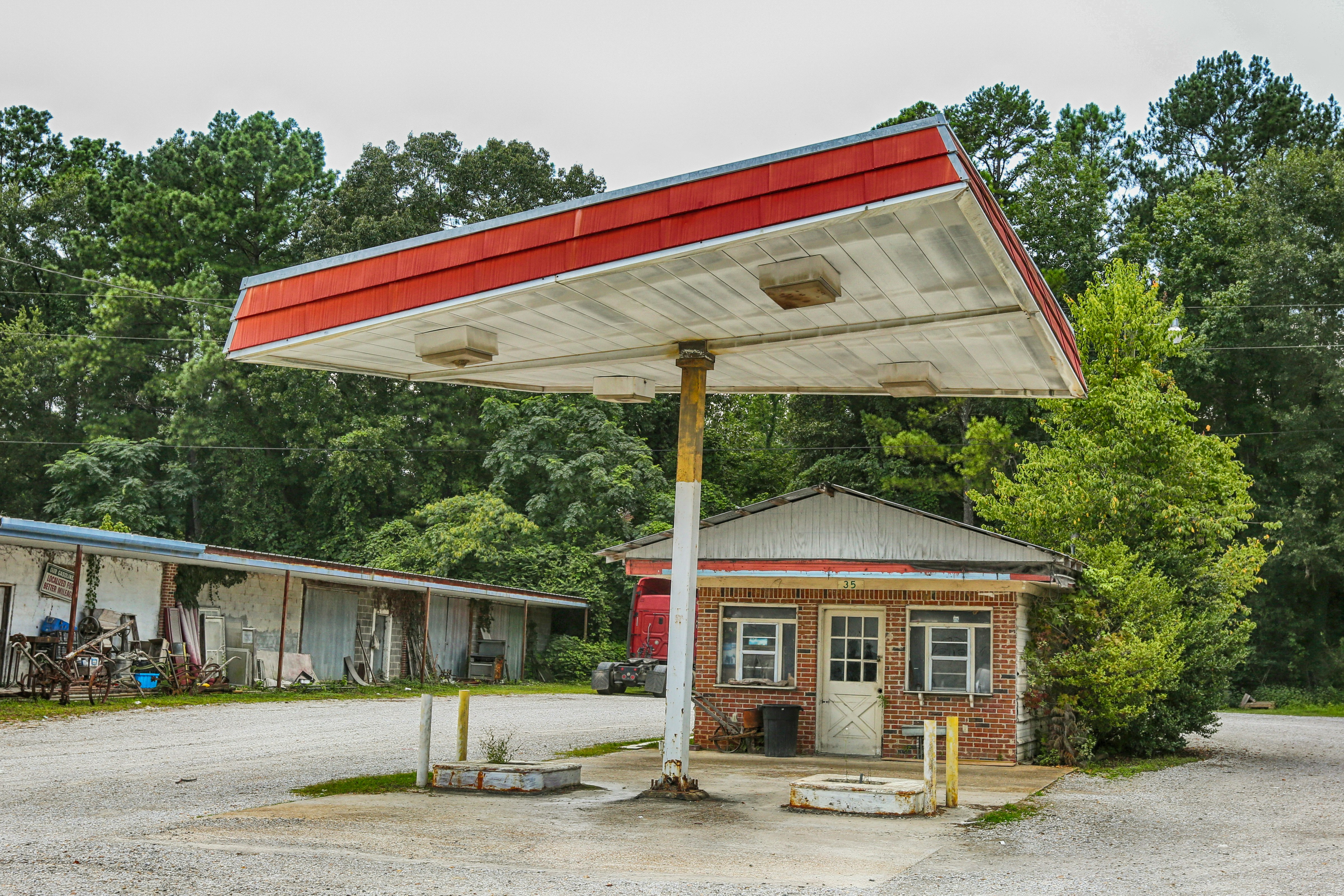 white and red concrete building near green trees during daytime